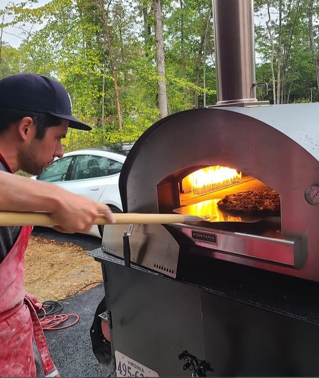 Pizzaiolo launching a pizza into the Fontana Forni oven