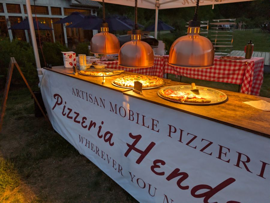 Pizza buffet under warm copper lamps at an evening event